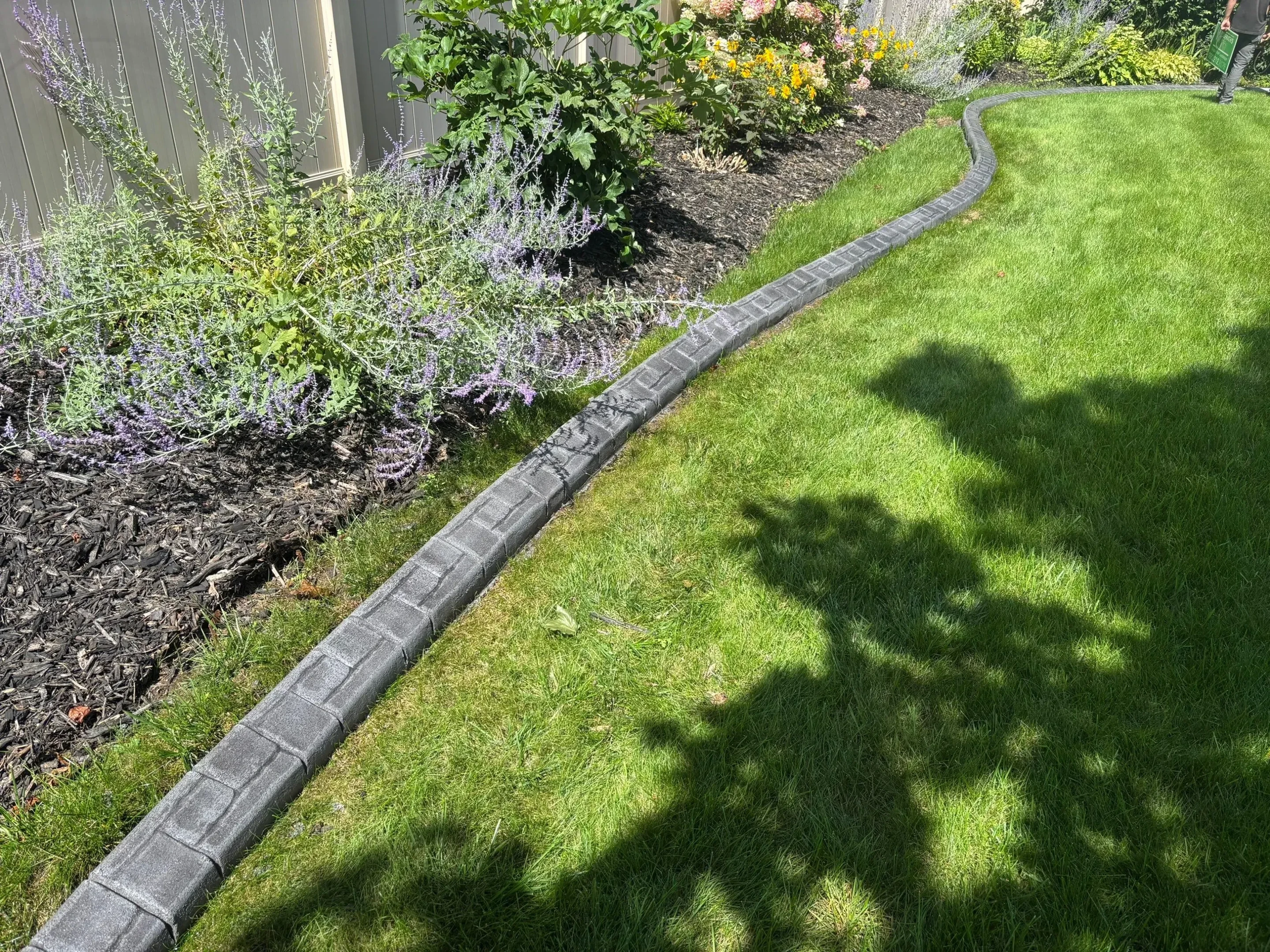 Professional landscape curbing tools and equipment on a Georgia residential property
