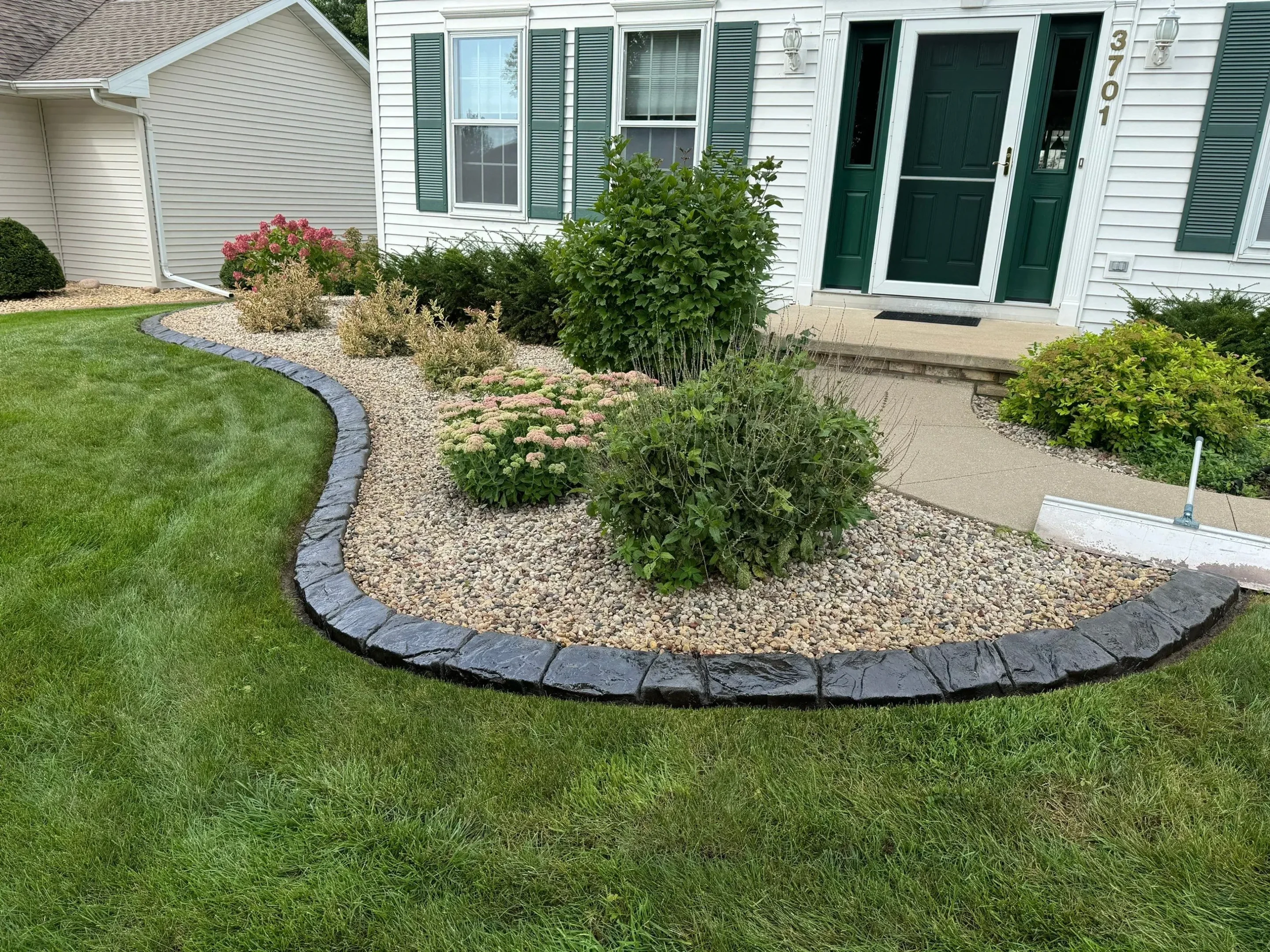 Concrete landscape curbing along a garden bed in Kennesaw, GA